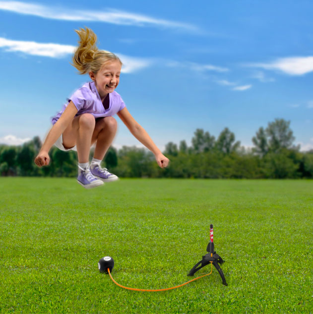 Girl jumping on a stomp rocket toy